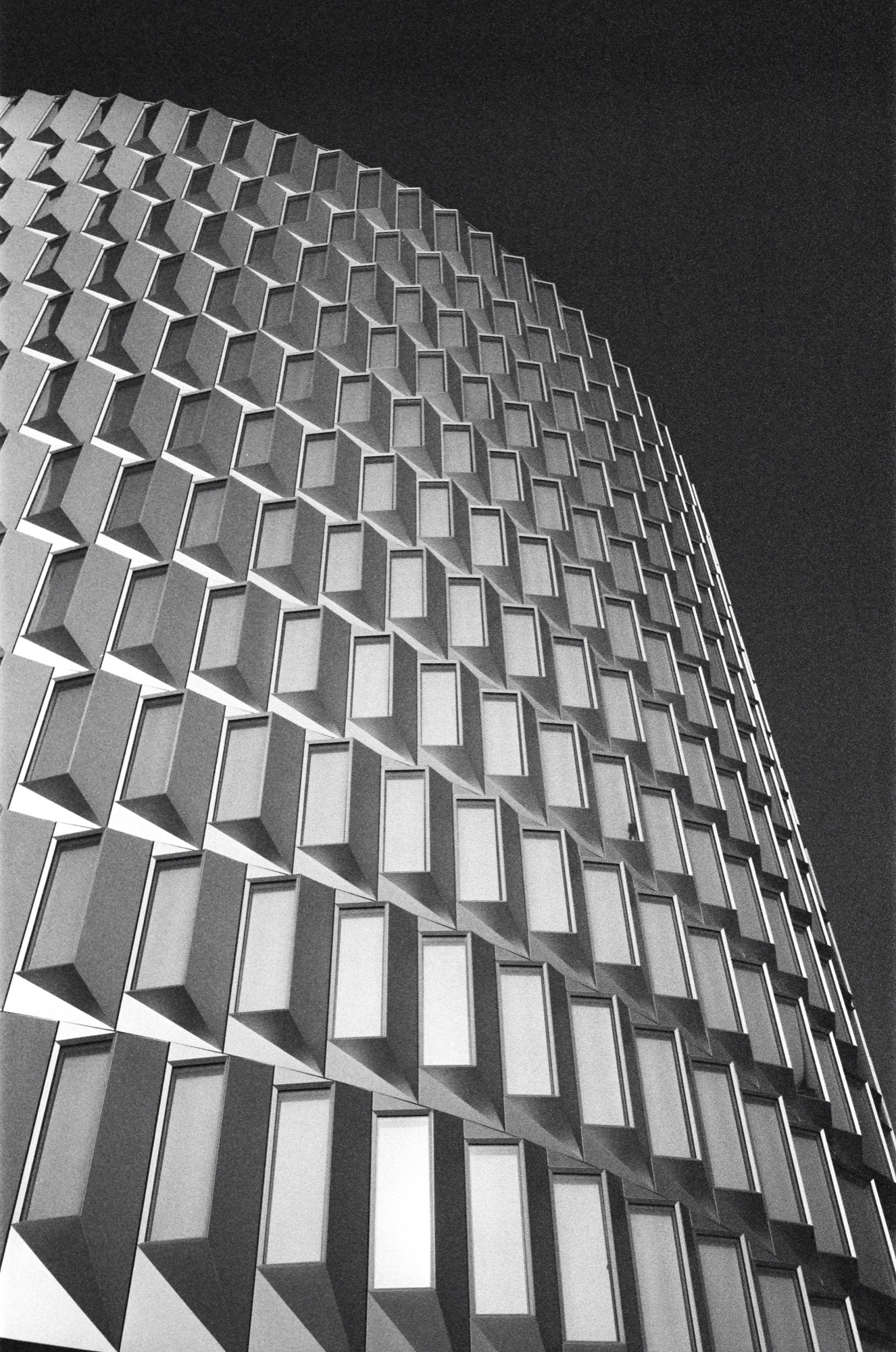 Modern building facade with repeating diamond-pattern windows