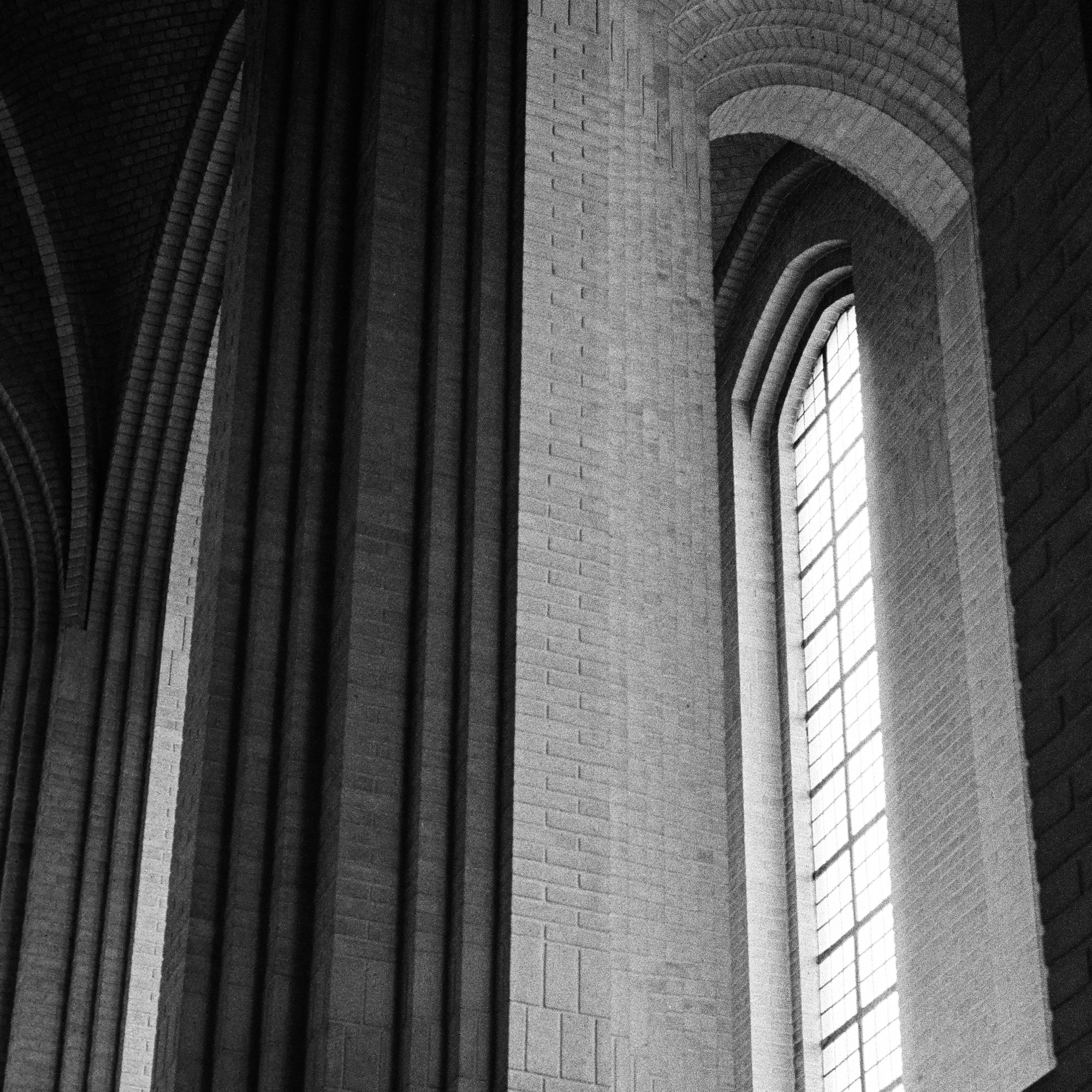 Cathedral interior with curved stone archways and tall window