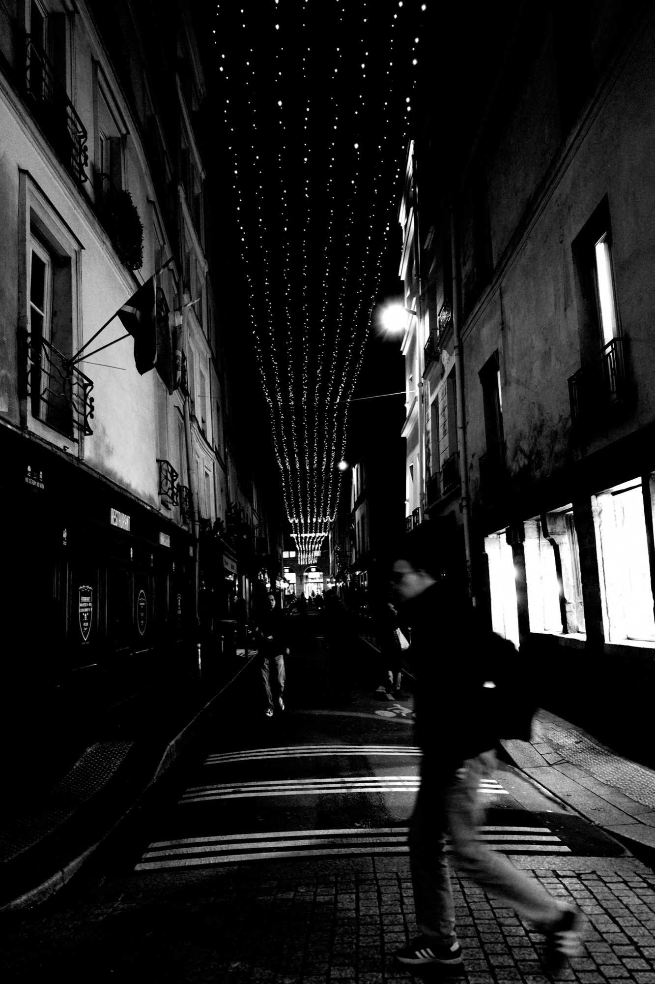 Nighttime street with decorative overhead string lights